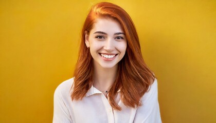 Portrait of beautiful cheerful redhead girl, yellow background 