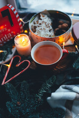 Obraz na płótnie Canvas A cup of tea with smoke in a Christmas atmosphere, mood