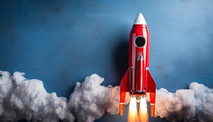 Red rocket with copy space, blue background 
