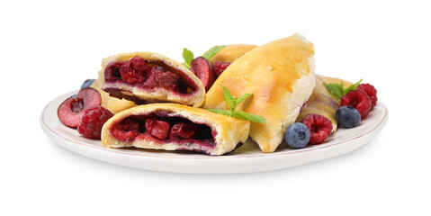 Plate of tasty samosas with berries and mint leaves isolated on white
