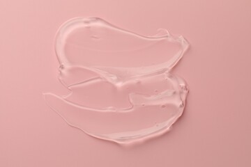 Sample of clear cosmetic gel on pink background, top view