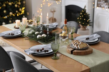 Christmas table setting with festive decor and dishware in living room