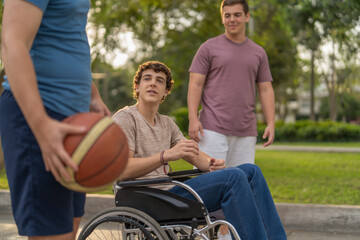 Disabled man and brothers playing basketball outdoors