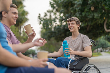 Fototapeta premium Disabled man and friends drinking coffee in a park