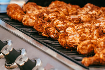 Grilled spiced chicken wings cooking on an outdoor grill