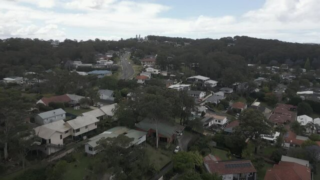 Low flight over tidy green streets of Warners Bay in NSW, Australia