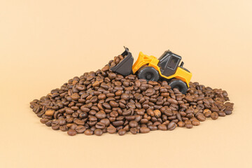 A bulldozer on a large pile of roasted coffee. © kvladimirv