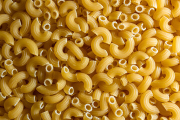 Uncooked Chifferi Rigati Pasta: A Culinary Canvas of Chifferi Rigati, Creating a Lively and Textured Background for Gourmet Cooking. Dry Pasta. Raw Macaroni - Top View, Flat Lay