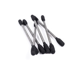 Group of black cotton buds isolated on a white background.
