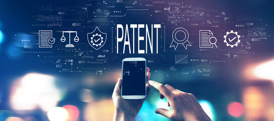 Patent concept with a smartphone in blurred city lights at night