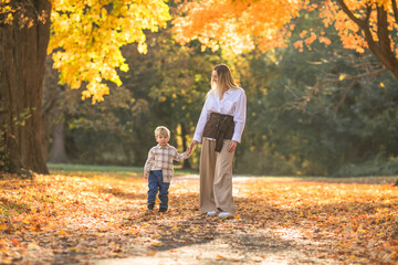 Fototapeta premium Mothers day, love family. Family on autumn walk in nature outdoors. Mother and child with hugging tenderness