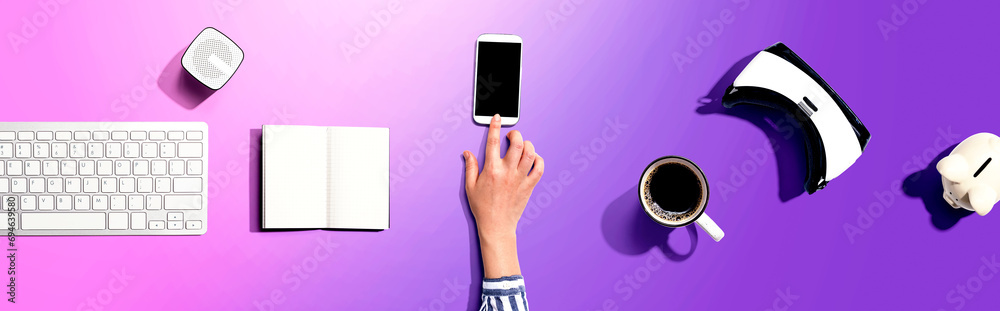 Poster person using a smartphone with a vr and a computer keyboard