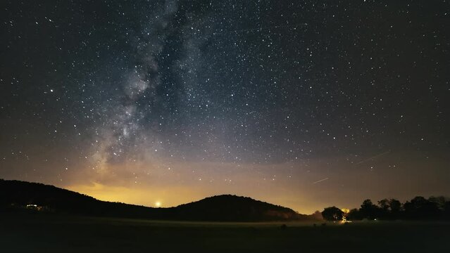Time-lapse of the Milky Way over a foggy field of cattle 