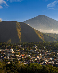 View from above of Sembalun, a small town in the northern part of the island of Lombok. Golden hour. Mount Rinjani in the distance. Indonesia