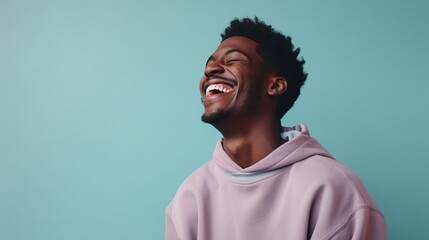 Fototapeta premium Laughing Black Man isolated on Minimalist Background. DEIB, Diversity, Equity, Inclusion, Belonging 