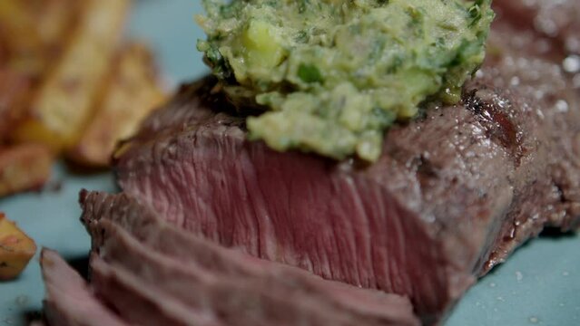 Grilled steak with Cafe Paris butter as an accompaniment, close up