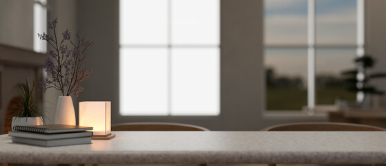 Copy space on a tabletop with a table lamp, a flower vase and books in a cosy home.