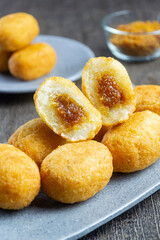 Misro is a typical snack from West Java Indonesia. This snack is made from grated cassava, the inside of which is filled with brown sugar and then fried. served on a plate with a dark table mat