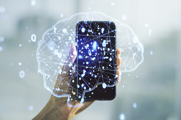 Creative artificial Intelligence concept with human brain hologram and hand with phone on...