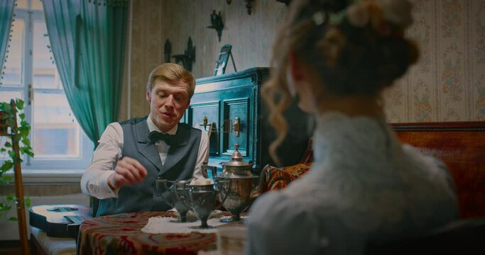 spouses drinking tea and talking after dinner in interior of 19 century, retro portrait, 4K, Prores