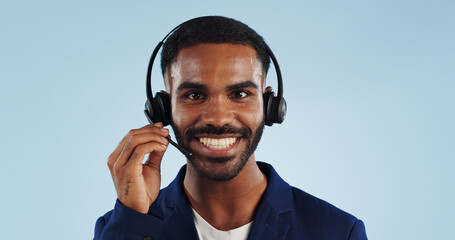 Happy businessman, portrait and headphones for call center or telemarketing against a blue studio...