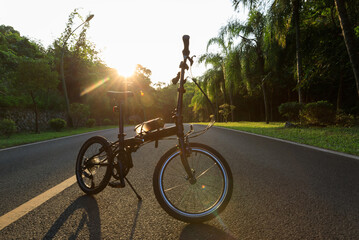 A folding bike on sunset road