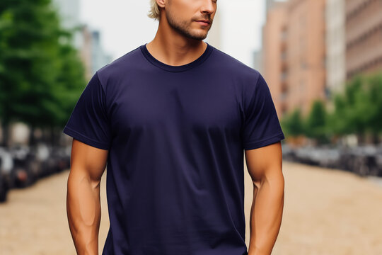 A man with a plain navy blue t-shirt, t-shirt mockup - Powered by Adobe