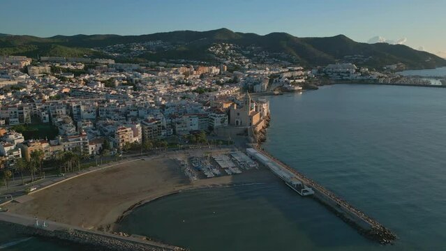 Aerial view over Sitges sunrise, Barcelona southwest, Yacht club and church
