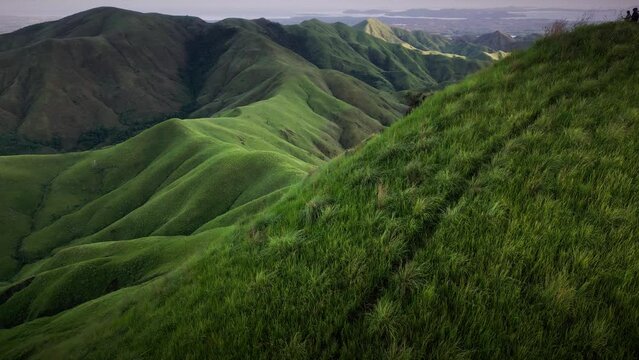 Aerial forward shot of Mount Labawan green grassland scenery ridge trail