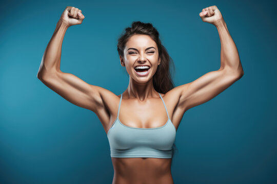 a young woman flexes her muscle and poses a photo of a gym