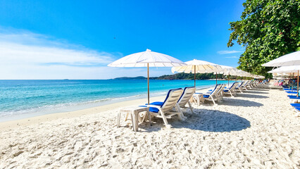 Koh Samet Island Rayong Thailand, beach chairs and sunbeds with umbrellas at the white tropical...