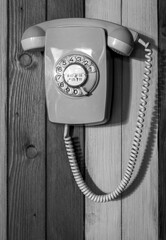 Old analogue cable telephone at a wall, close-up picture