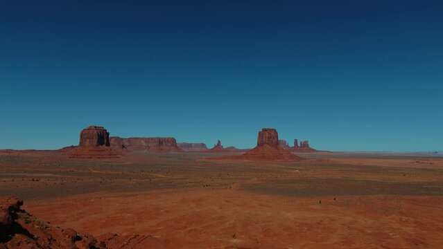 Monument Valley panorama in Utah and Arizona. Red rock formations in scenic iconic wild west landscape.