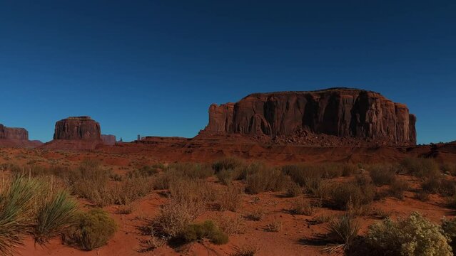 Monument Valley in Arizona and Utah. Driving along red rock formations in iconic scenic wild west landscape.