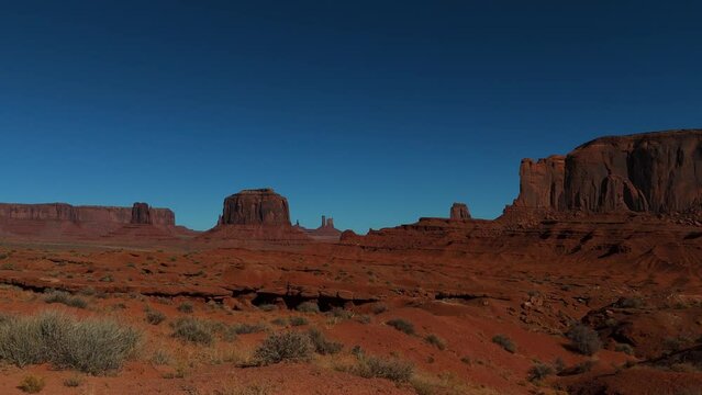Monument Valley in Utah and Arizona. Driving along red rock formations in iconic scenic wild west landscape.