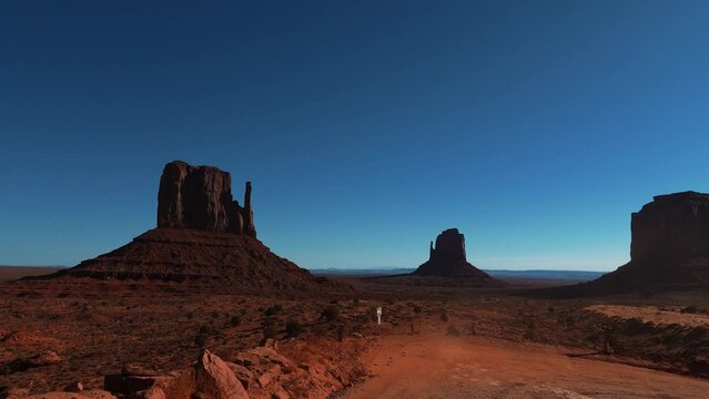Monument Valley in Arizona and Utah. Driving through red rock formations in scenic iconic wild west landscape.