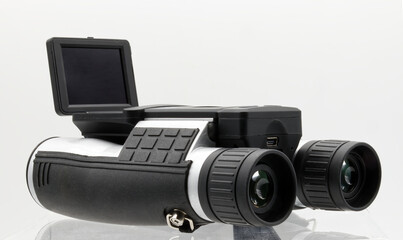 Modern binoculars with digital camera LCD display isolated on white