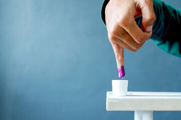 Inked pinky finger. Purple ink blots from voter's finger provides evidence of the presidential...