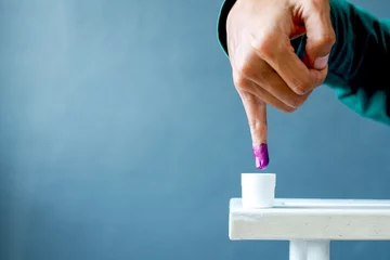 Foto op Plexiglas Inked pinky finger. Purple ink blots from voter's finger provides evidence of the presidential election in Indonesia. © Gatot