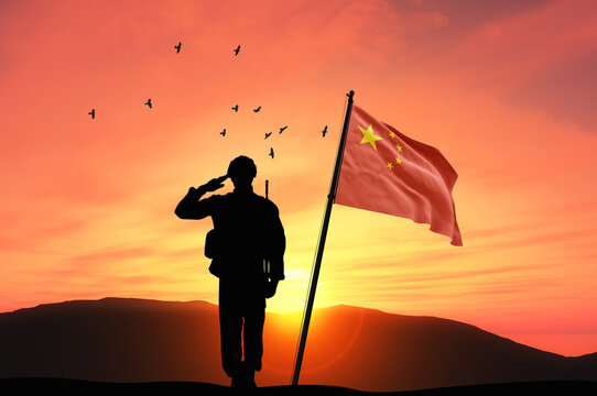 Silhouette of a soldier with the China flag stands against the background of a sunset or sunrise. Concept of national holidays. Commemoration Day.