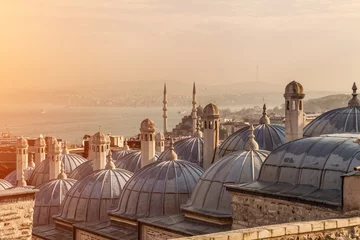 Fotobehang The domes of Suleymaniye Mosque, with the Bosphorus Strait and Galata Bridge in the distance. © Hustiu
