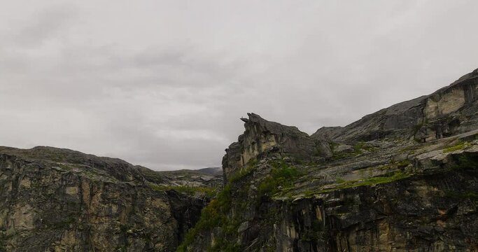Aerial approach toward The Canon rock formation in dramatic alpine landscape