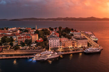 Zadar, Croatia - Aerial view of the Old Town of Zadar at dusk with mooring yachts, Cathedral of St....