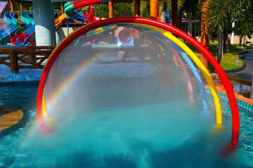 Amezing natural rainbow appear on colorful curve of
amusement background in water park.