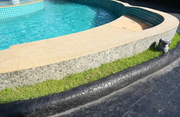 The curve of swimming pool against sunrise in afternoon,small waving in pool,summertime.