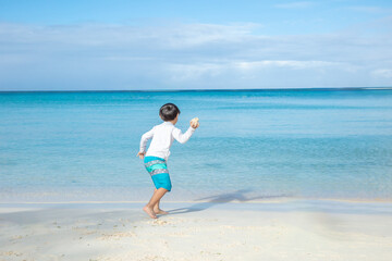 Fototapeta na wymiar 砂浜で遊ぶ子ども　children playing on the sandy beach