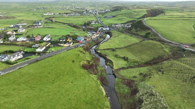drone flying up river over Doolin Village west of Ireland on the wild Atlantic way