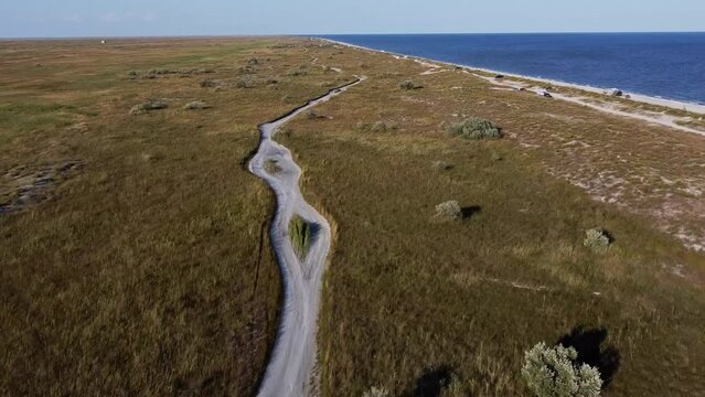 Drone approaching Vadu Beach, passing over the plains and grasslands at the beachfront facing  the Black Sea, located in Constanta County, in Romania.