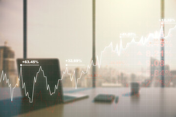 Double exposure of abstract creative financial chart and modern desktop with laptop on background, research and strategy concept