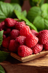 Ripe juicy raspberries with leaves.
